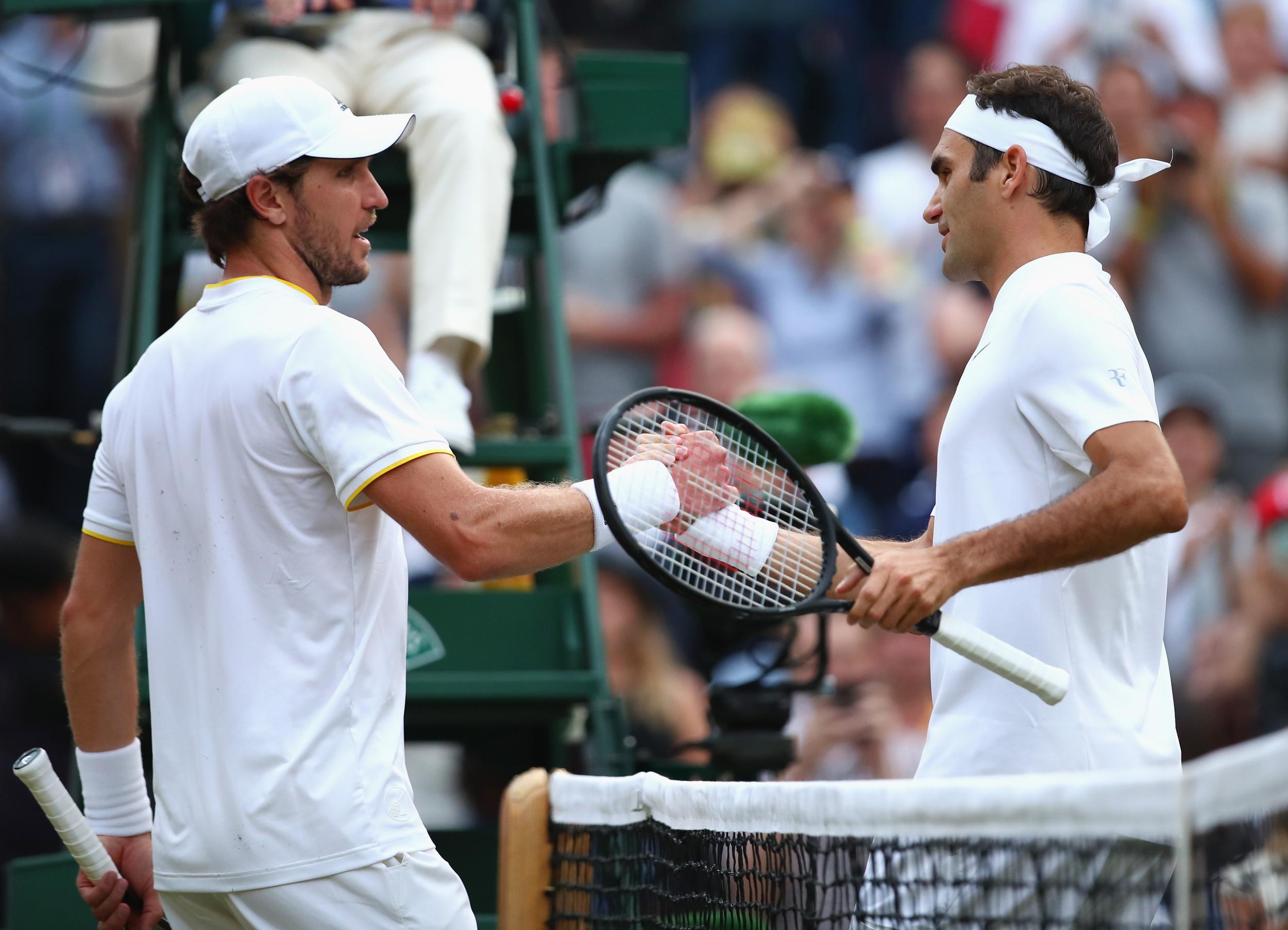 Federer and Zverev shake hands at the net