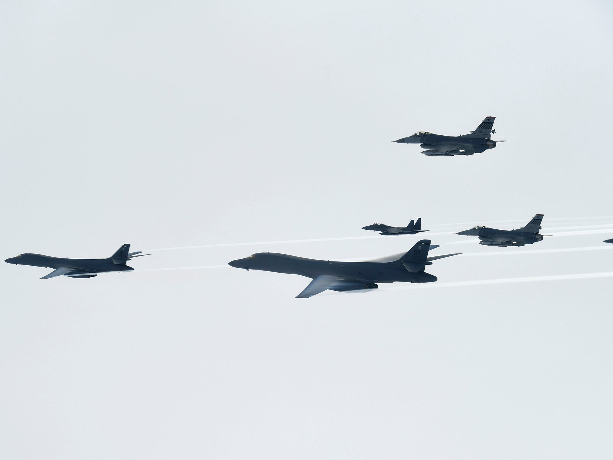 US Air Force B-1B Lancer bombers, left and second from left, fly with South Korean and US fighter jets over the Korean Peninsula, South Korea. Photo provided by the South Korea Defense Ministry.