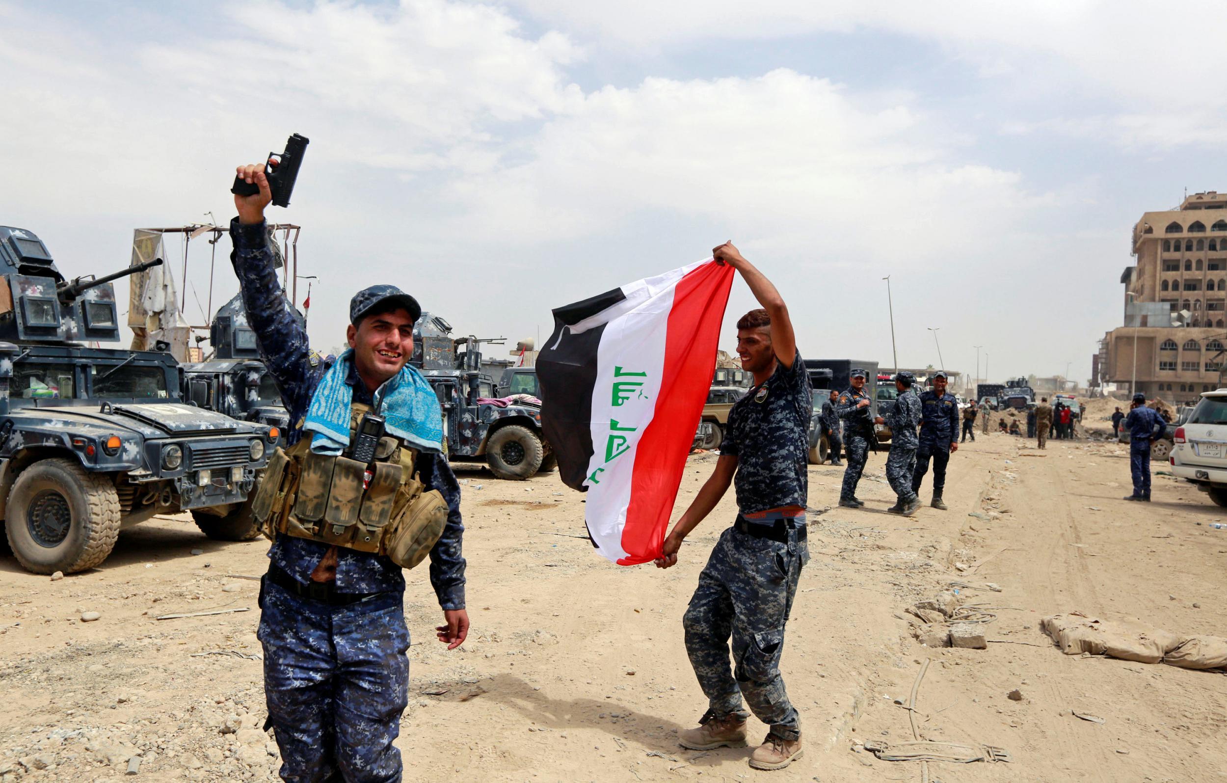 Iraqi Federal Police celebrate in the Old City of Mosul