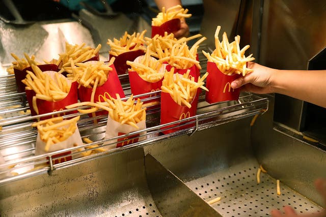 McDonald's crew member Samantha Medina prepares french fries as the McDonald's restaurant stock price reached record territory on April 25, 2017 in Miami, Florida