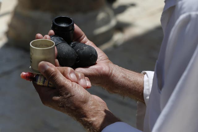 Man holds new black sponge-tipped bullets used by Israeli police