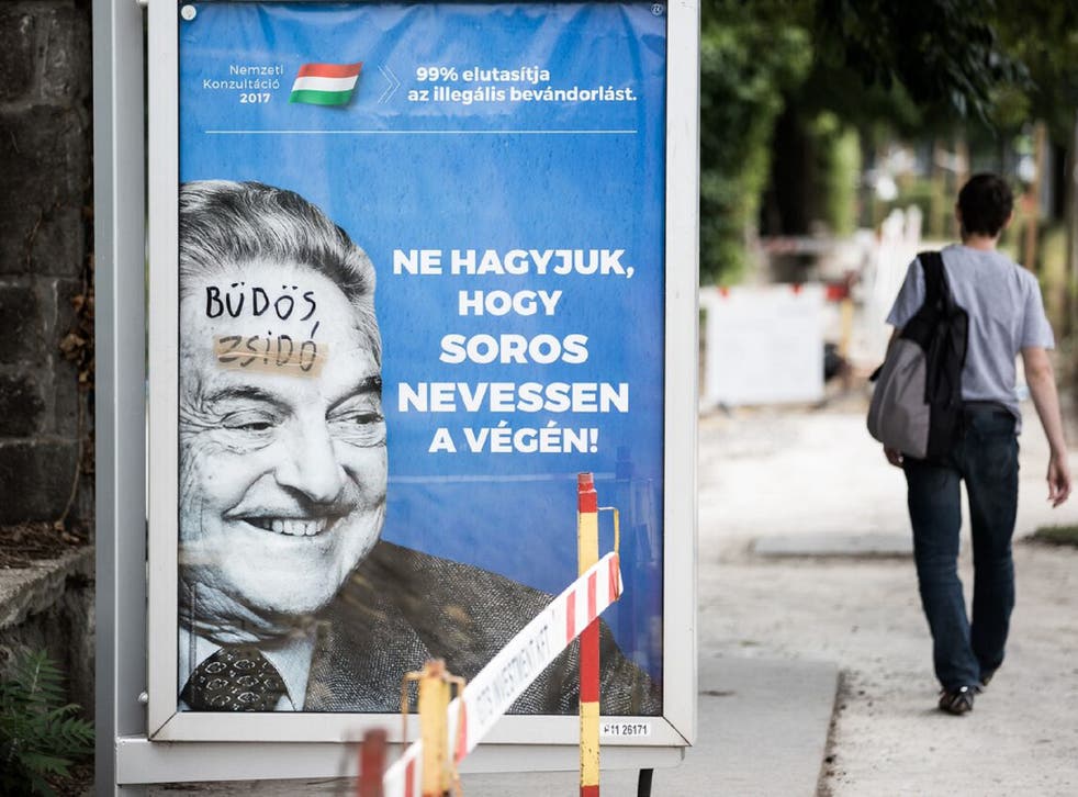 Billboards with images of George Soros have been defaced with graffiti that reads 'stinking Jew'