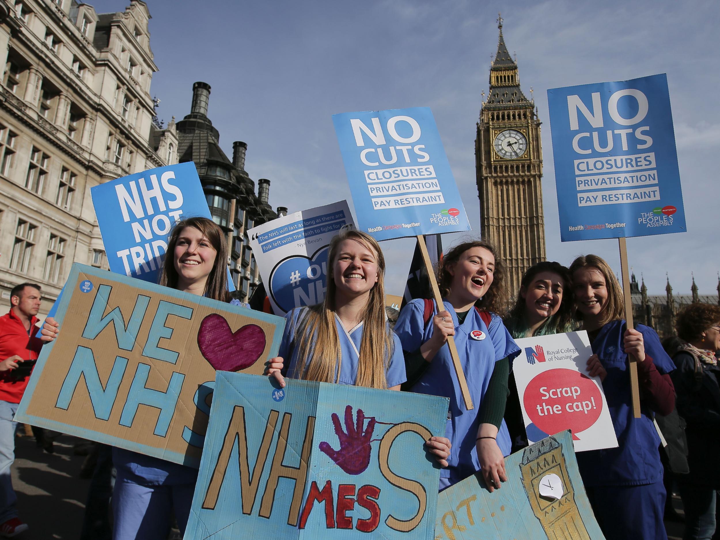 Protesters at a demonstration against cuts to NHS funding in central London