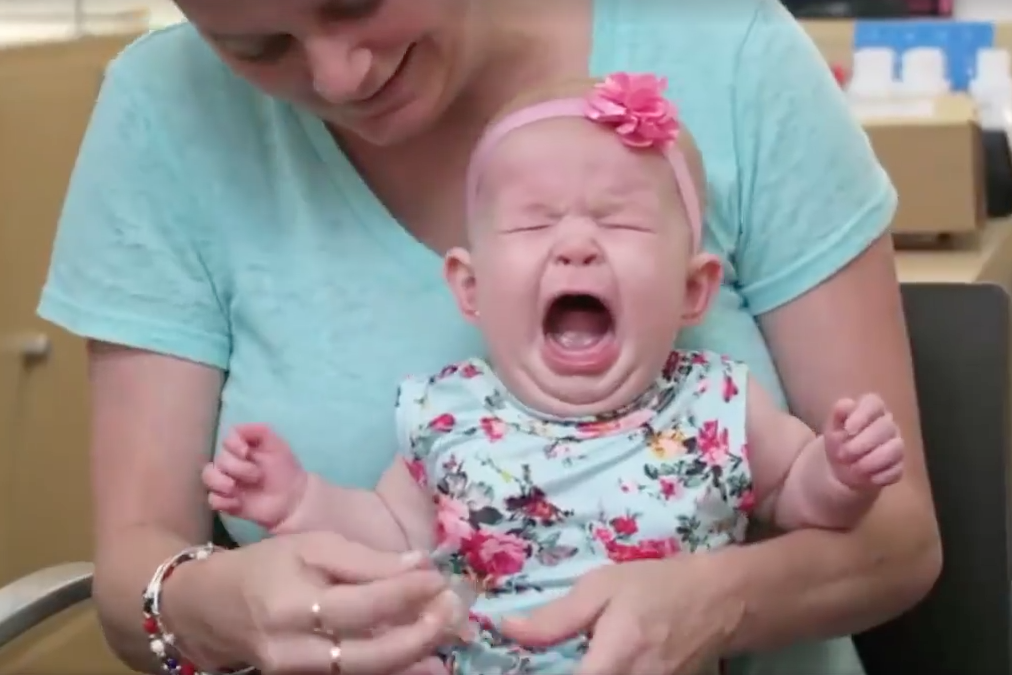 The startled youngster cries out while the mother and staff do their best to comfort her