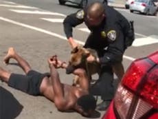 Police dog mauled handcuffed black man screaming 'uncomfortable' 