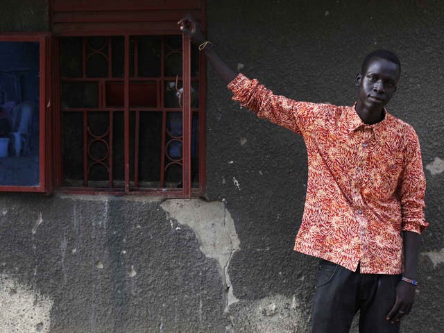 Jalpan Bol, a student, painter and member of Ana Taban poses for a photograph in his compound, in Juba
