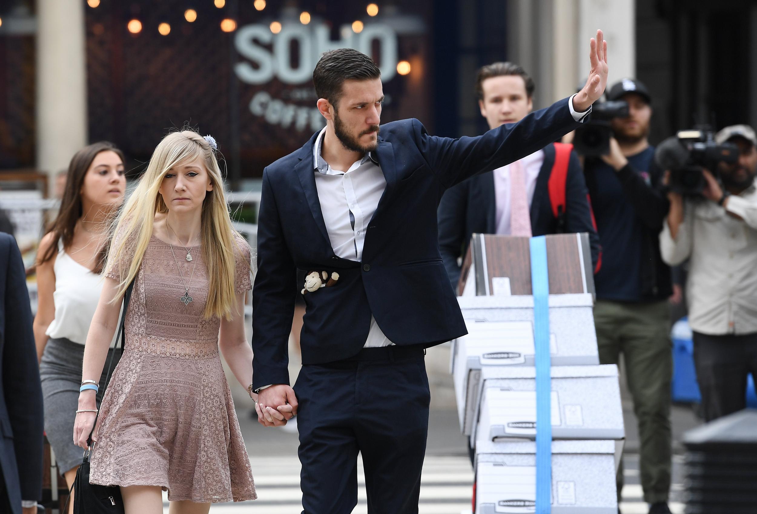 The parents of Charlie Gard, Connie Yates (L) and Chris Gard (c), arrive at the High Court