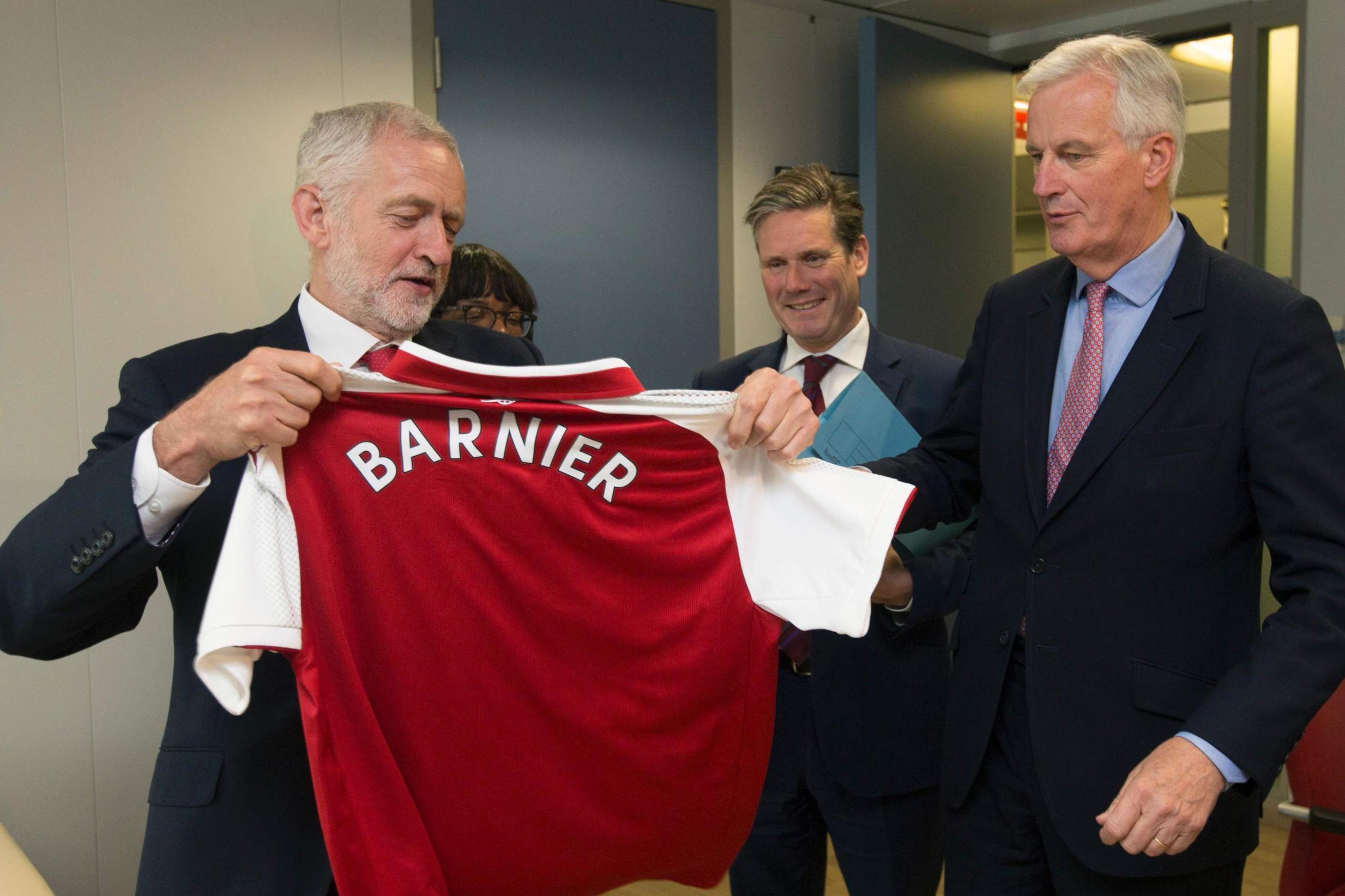 Jeremy Corbyn presenting the EU’s Michel Barnier with an Arsenal shirt