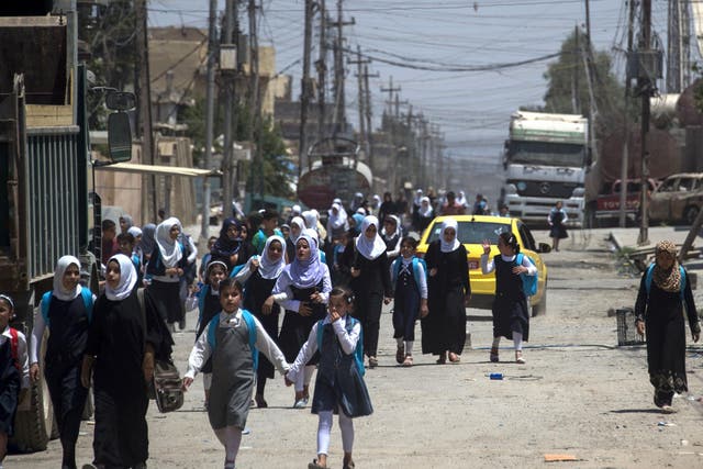 Iraqi girls walk back from school in west Mosul after the government declared it had driven the Islamic State from its one-time stronghold