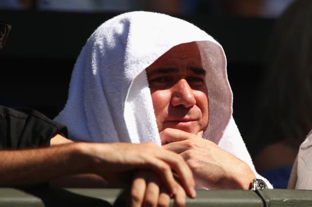 The tennis icon cooled off in the heat by hiding under a white towel