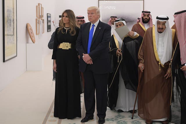 Saudi Arabia's King Salman bin Abdulaziz al-Saud, US President Donald Trump and US First Lady Melania Trump look at a display of Saudi modern art at the Saudi Royal Court in Riyadh