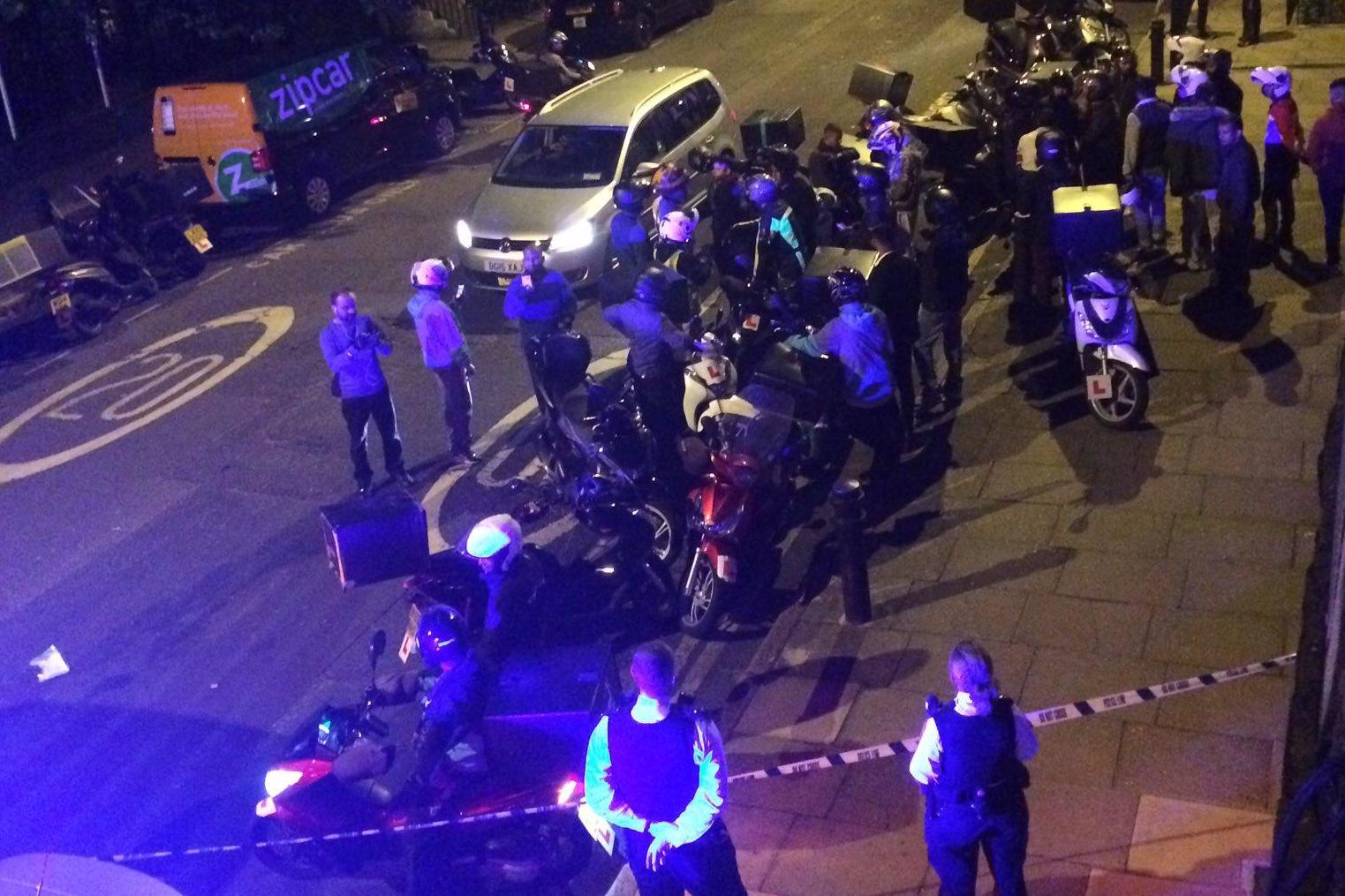 Police at the scene of a recent acid attack in East London