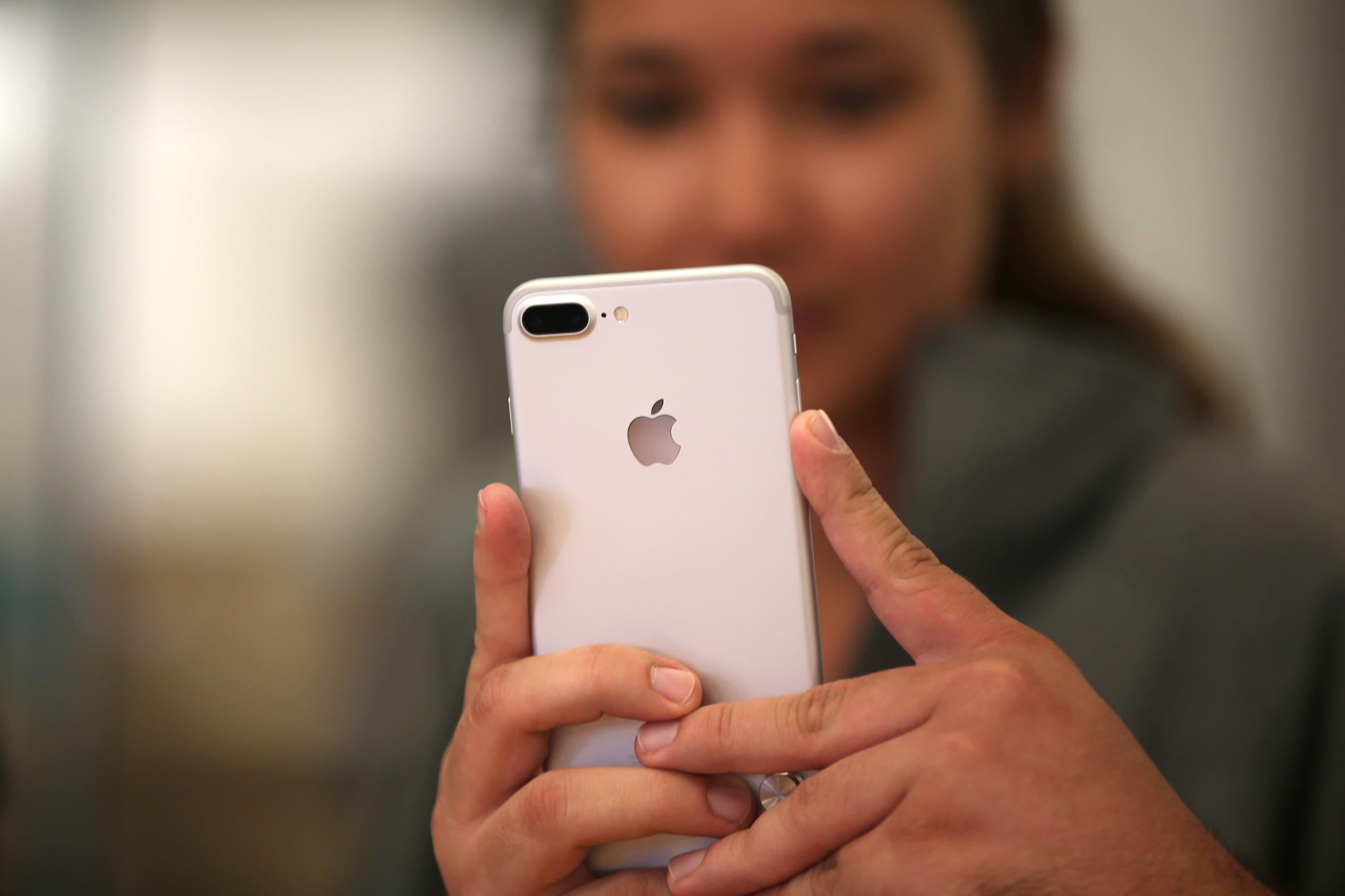 A customer views the new iPhone 7 smartphone inside an Apple Inc. store in Los Angeles, California, U.S., September 16, 2016