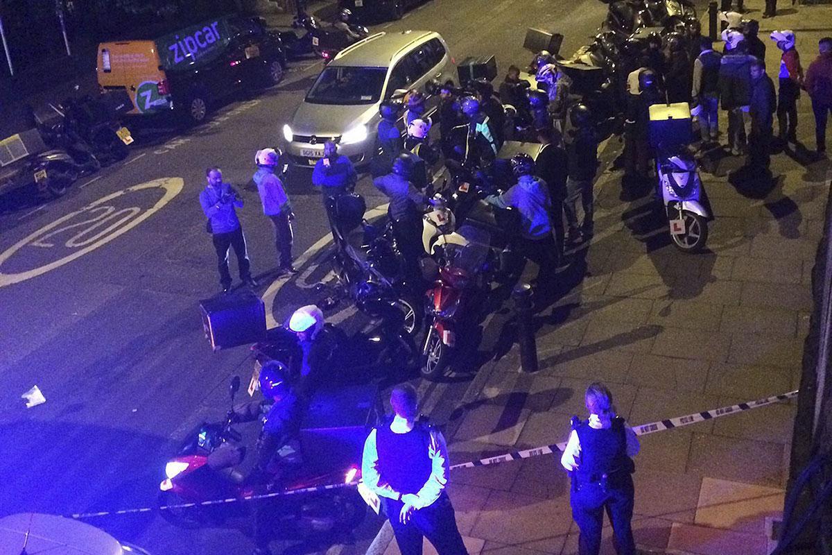 Police at the scene of one of five acid attacks in London on 13 July