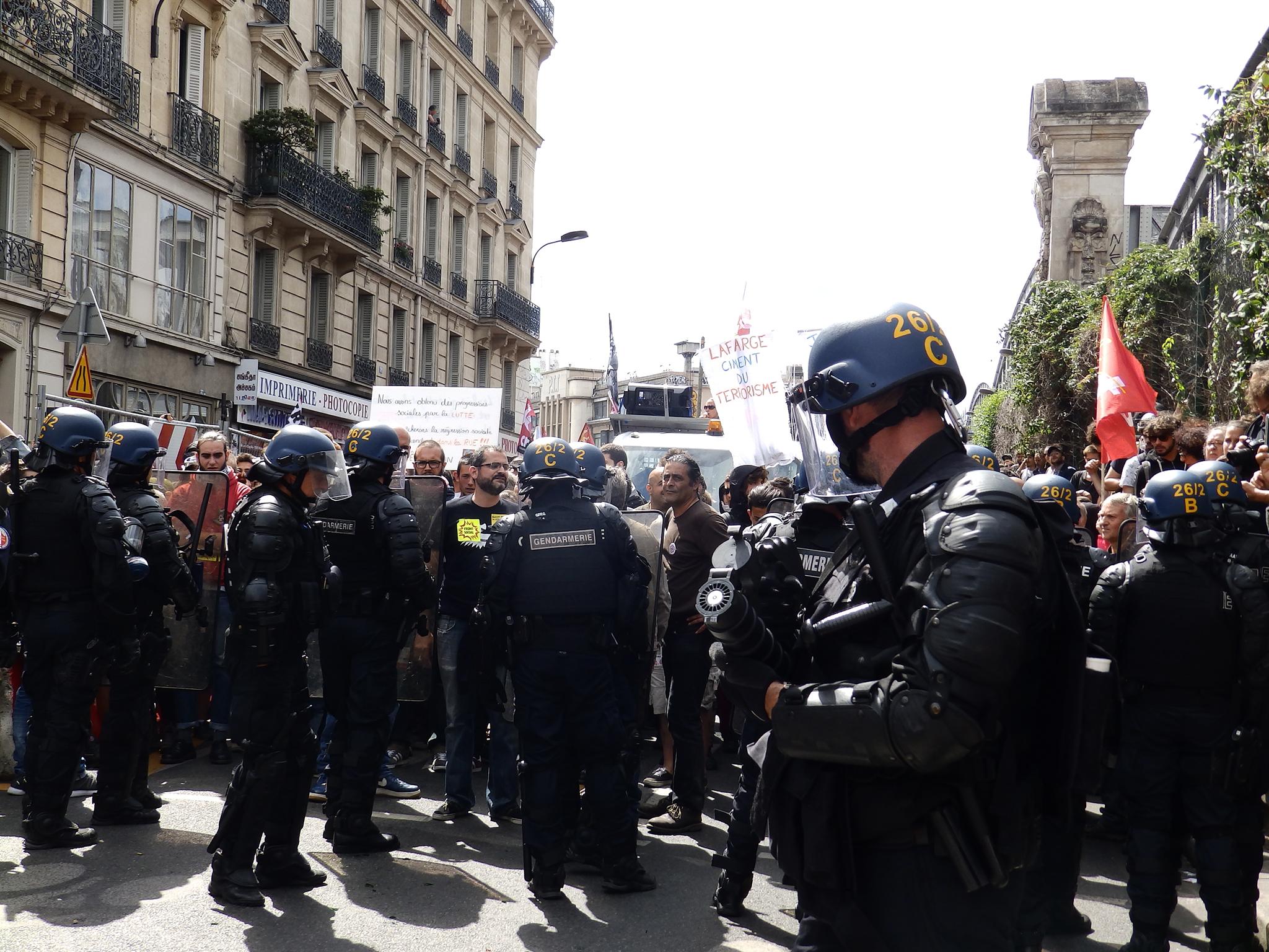 Gendarmes hold back protesters near Paris’s Gare du Nord station