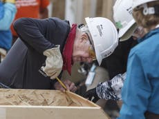 Jimmy Carter, 92, builds homes for poor while Trump watches golf