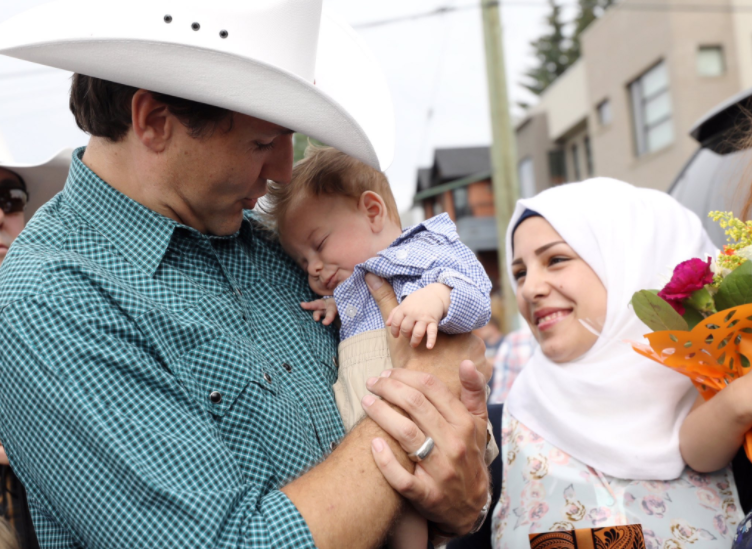 The get-together took place at the Calgary Stampede where the baby snoozed contently while Mr Trudeau held him