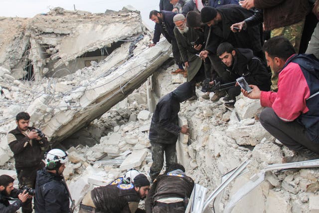 White Helmets digging through the rubble of a mosque in Aleppo province following a US airstrike