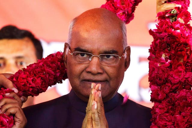 Supporters of Ram Nath Kovind, present him with a garland during a welcoming ceremony as part of his nation-wide tour, in Ahmedabad, India