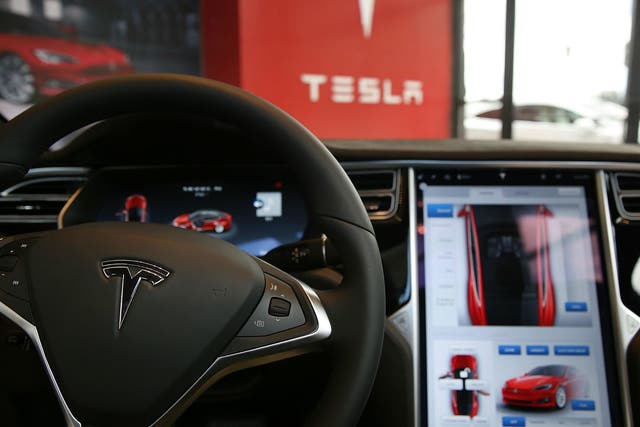 The inside of a Tesla vehicle is viewed as it sits parked in a new Tesla showroom and service center in New York City
