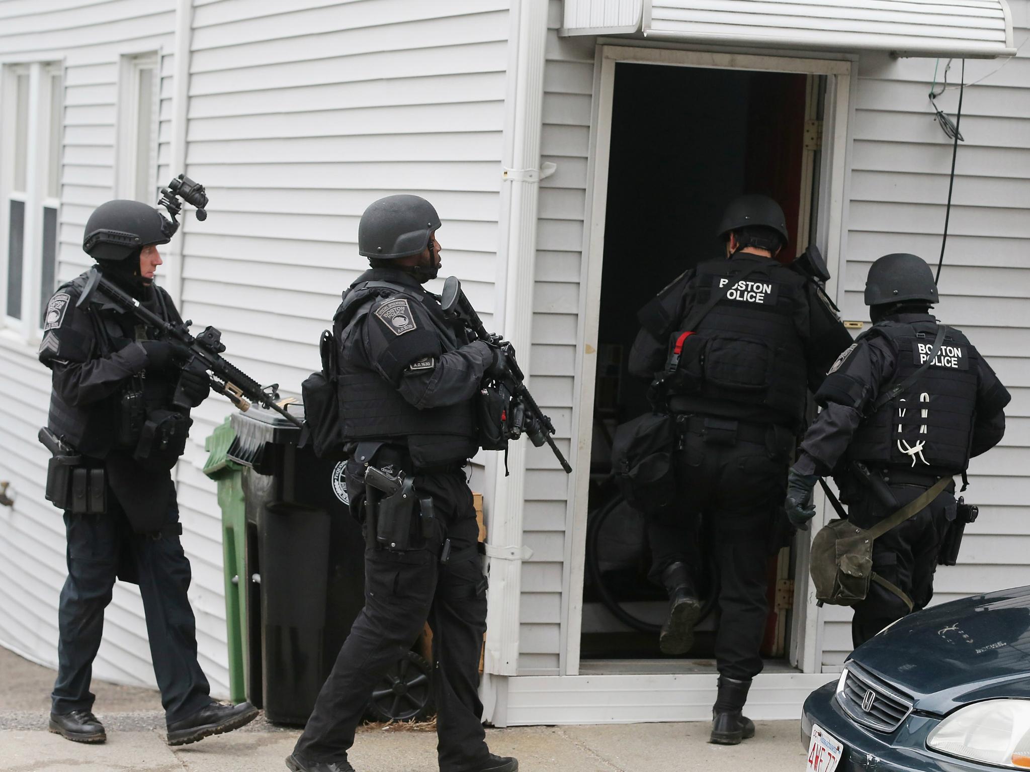 SWAT team members enter a residential building in Watertown, Massachusetts. A similar type of police team showed up at the Reeves' home on 15 July 2017.