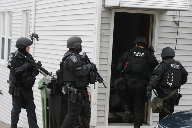  SWAT team members enter a residential building in Watertown, Massachusetts. A similar type of police team showed up at the Reeves' home on 15 July 2017.
