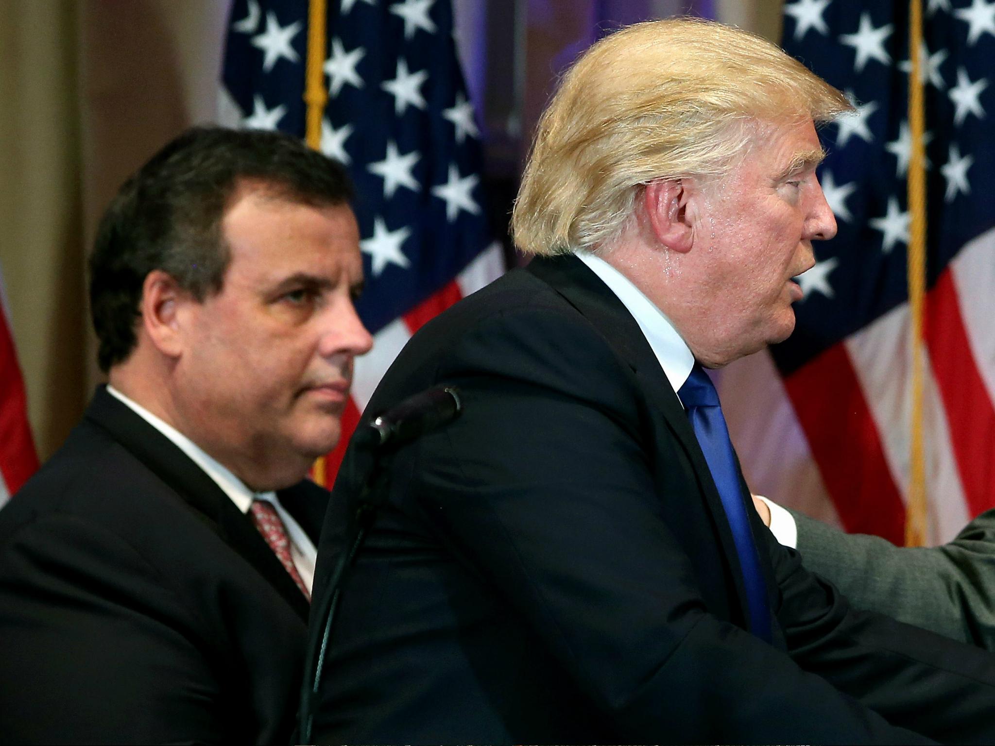 New Jersey Governor Chris Christie accompanies then-Republican Presidential frontrunner Donald Trump off the stage after a press conference on Super Tuesday, 1 March 2016 in Florida