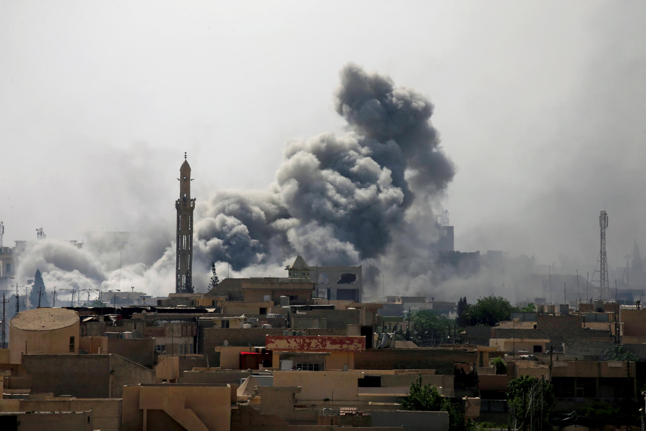 Smoke rises from an air strike during a battle between Iraqi forces and Isis in west Mosul