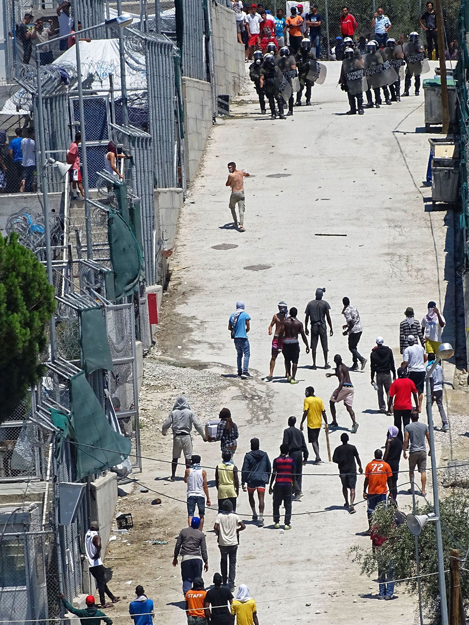 Migrants clash with riot police while protesting to demand better living conditions at the Moria asylum centre on Lesbos, Greece, on 18 July 2017.
