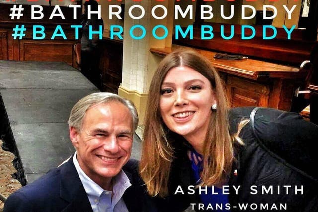 A transgender woman poses with an unwitting Texas Governor Greg Abbott as debate on a controversial bill limiting transgender people's use of public bathrooms continues