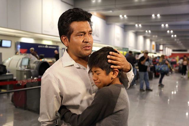 Mr Lara Lopez comforts his son before being deported to Mexico after 16 years in the US