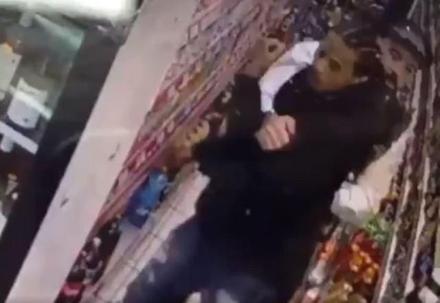 CCTV shows Mr Charles being apprehended by a police officer at the shop in Dalston