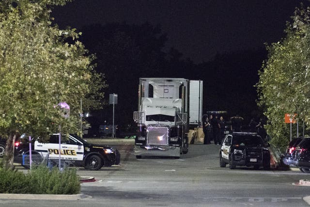 Officials investigate a truck that was found to contain 38 suspected illegal immigrants and eight dead bodiesin San Antonio
