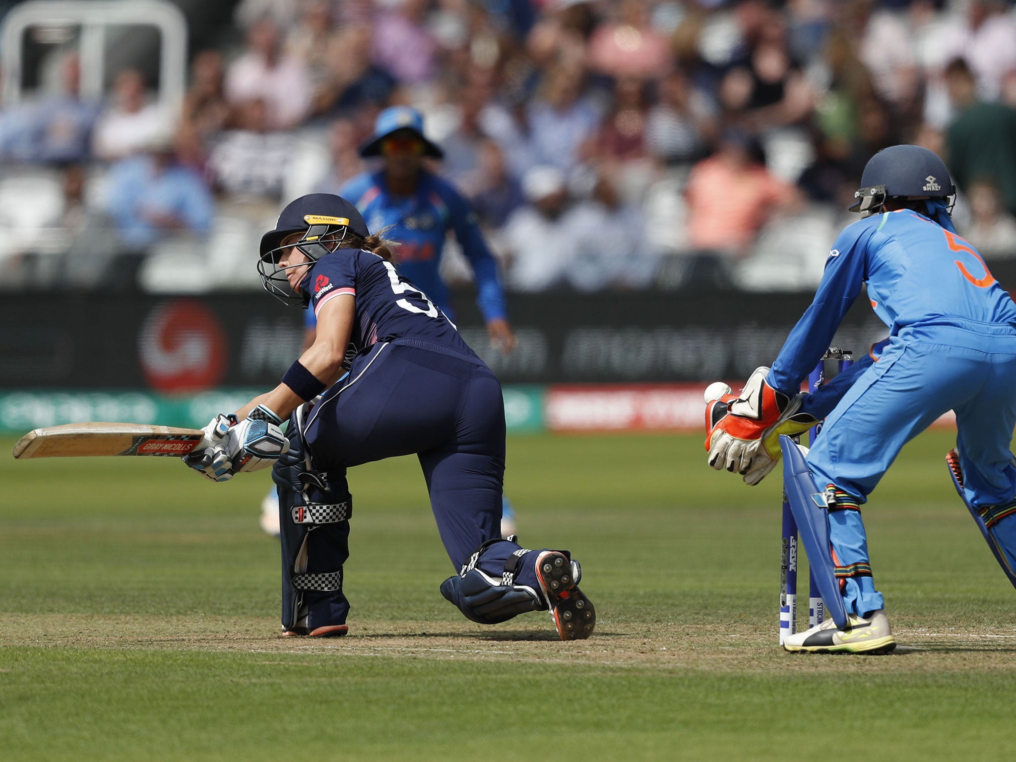 Lauren Winfield loses her wicket by India's keeper Sushma Verma