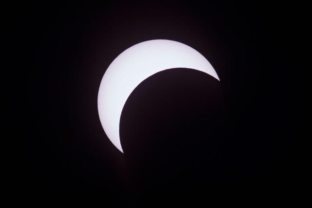 Picture taken on February 26, 2017 showing the moon moving to cover the sun for an annular solar eclipse