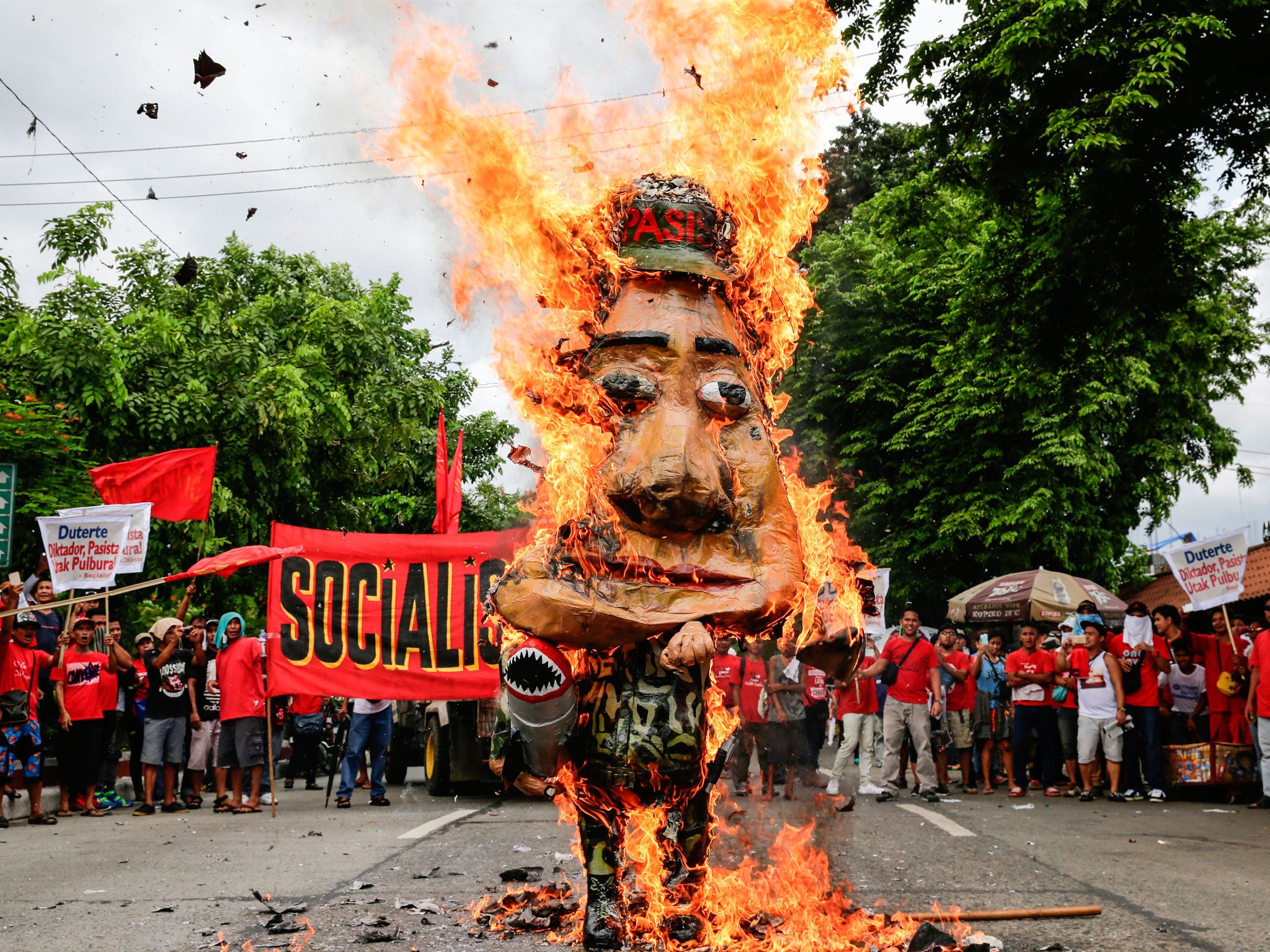 Activists burn an effigy of Mr Duterte in Quezon City, northeast of Manila, where the speech was taking place