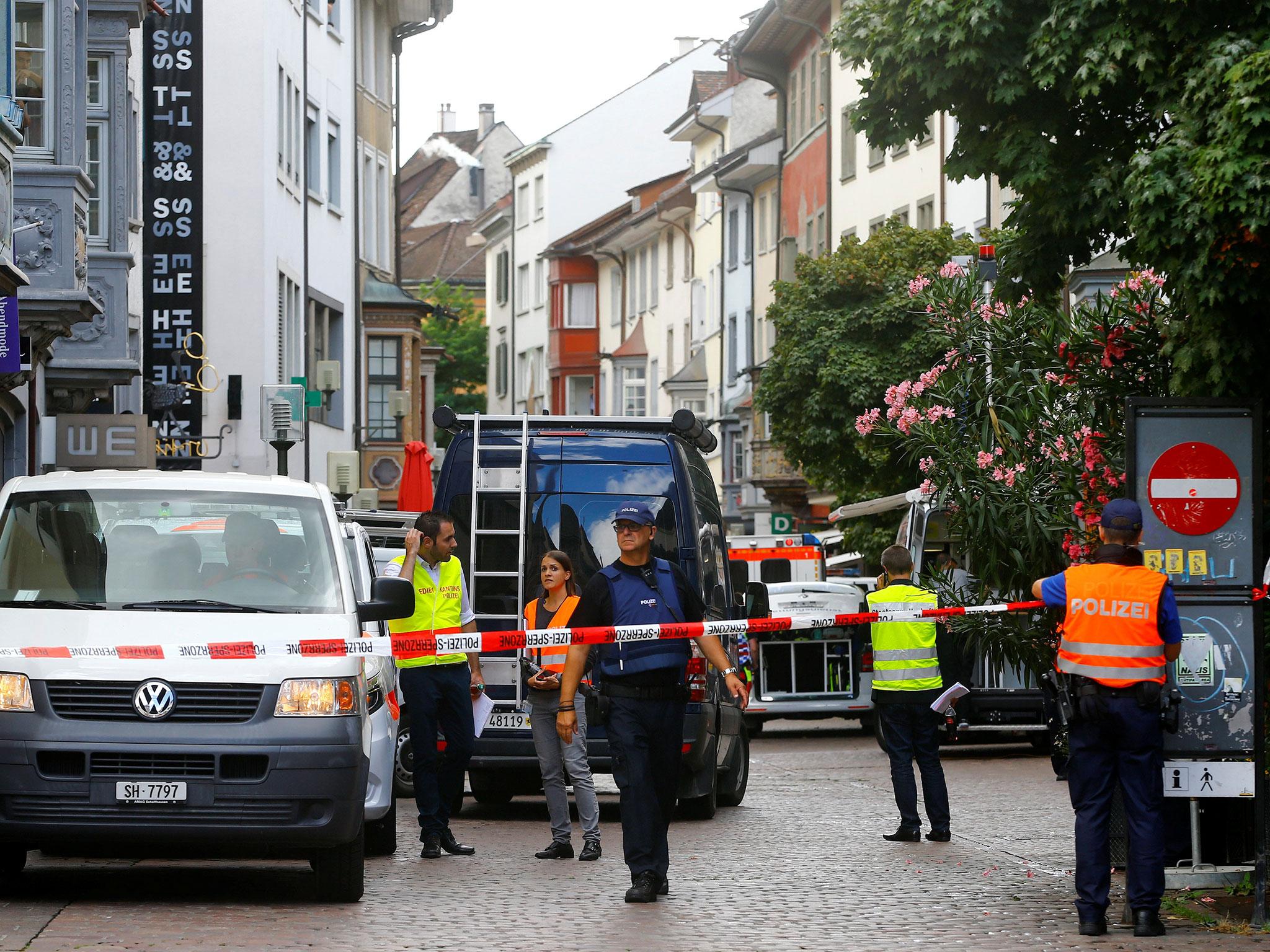 Swiss police officers stand at a crime scene in Schaffhausen, Switzerland