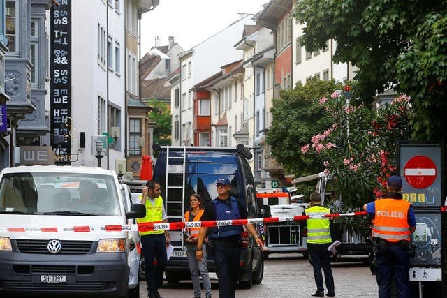 Swiss police officers stand at a crime scene in Schaffhausen, Switzerland