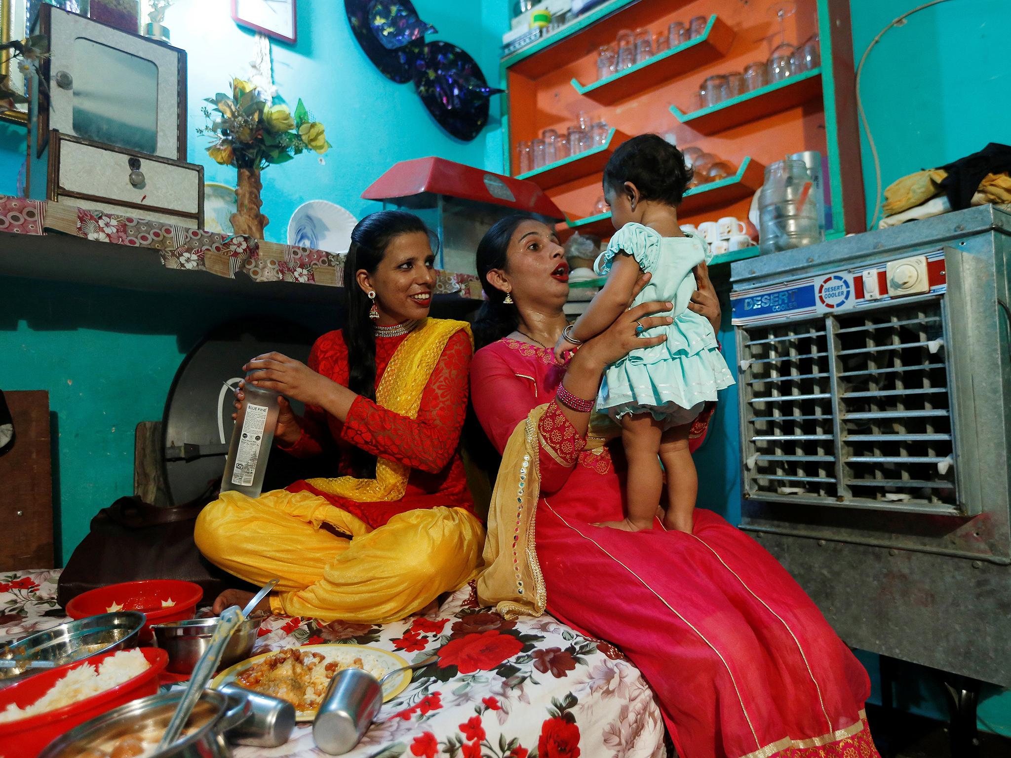 Bouncer Tarannum (L) a shares a moment with her friend during Eid al-Fitr celebrations at her house in New Delhi, India, June 26, 2017. REUTERS/Adnan Abidi