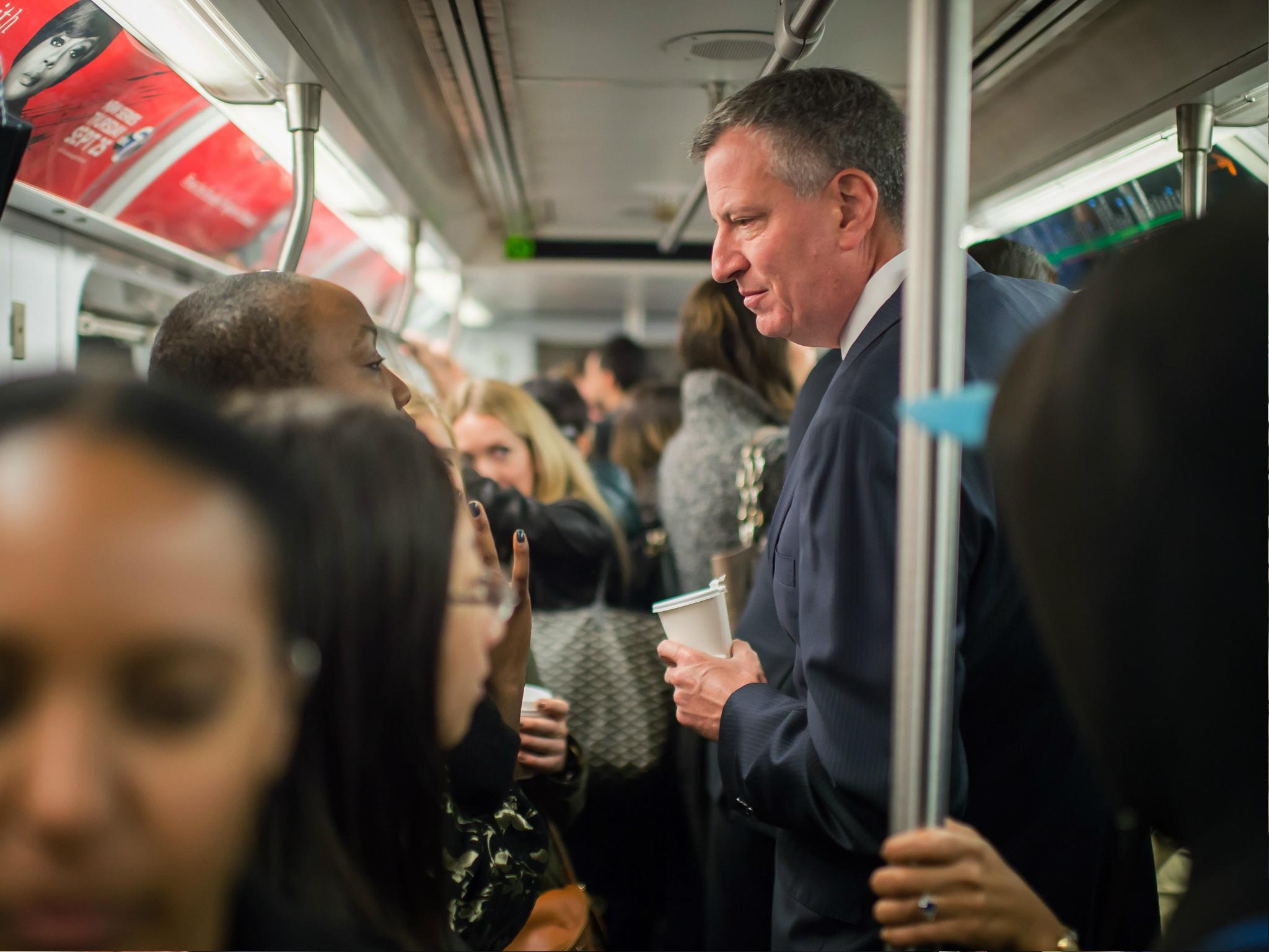 In this image handout provided by the Office of Mayor of New York, Mayor Bill de Blasio takes the subway on his route to City Hall, on 24 October 2014 in New York Cit
