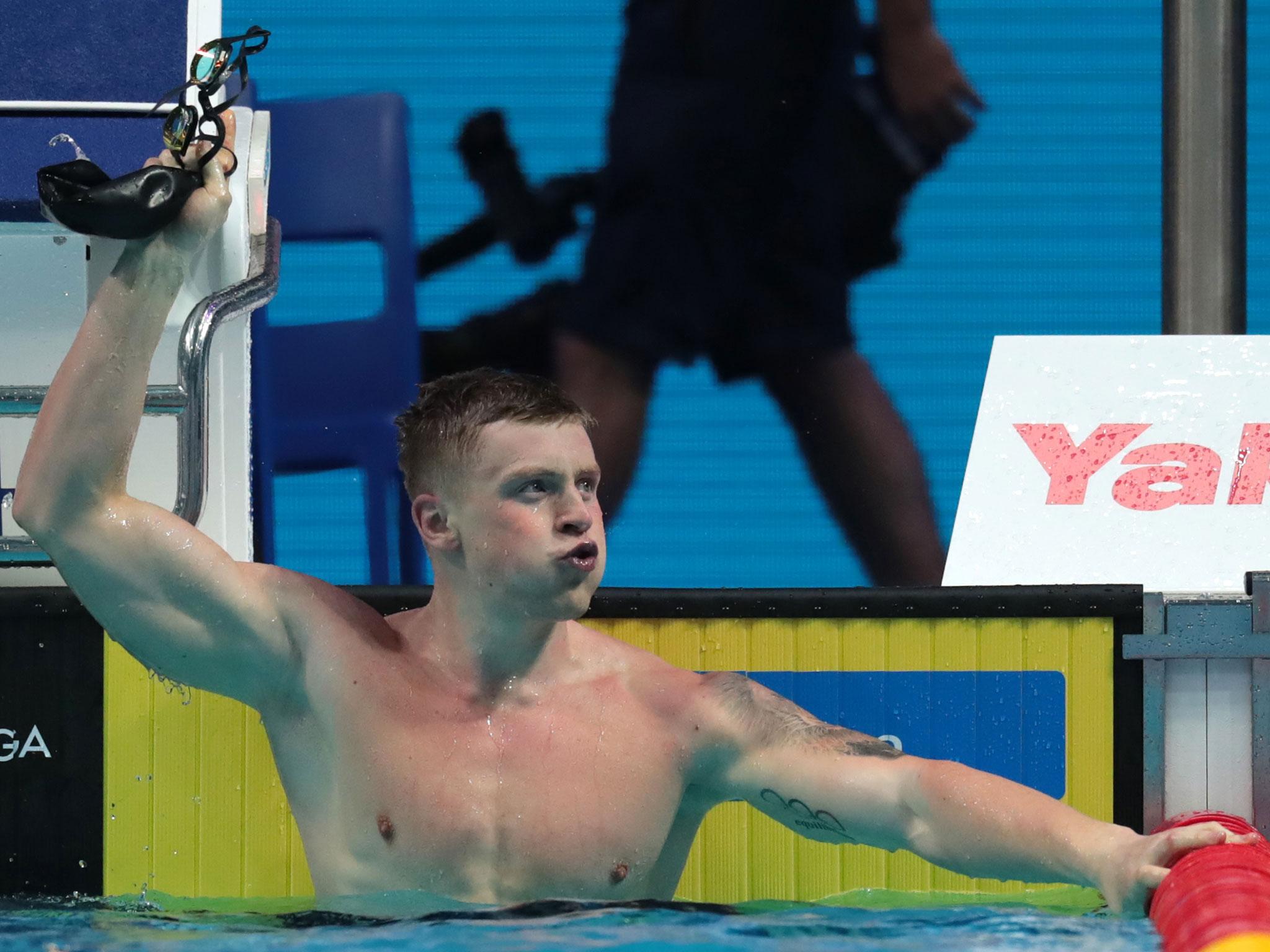 Adam Peaty celebrates after swimming to gold