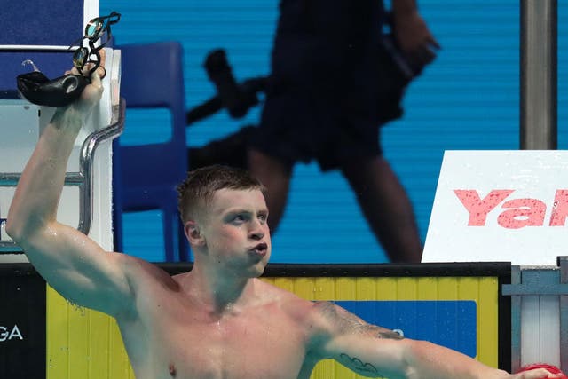 Adam Peaty celebrates after swimming to gold