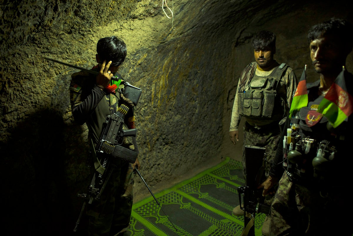 Inside the former Isis-K building in the Momand Valley that is now a government checkpoint, an Afghan commando holds a bayonet he says belonged to a rebel fighter