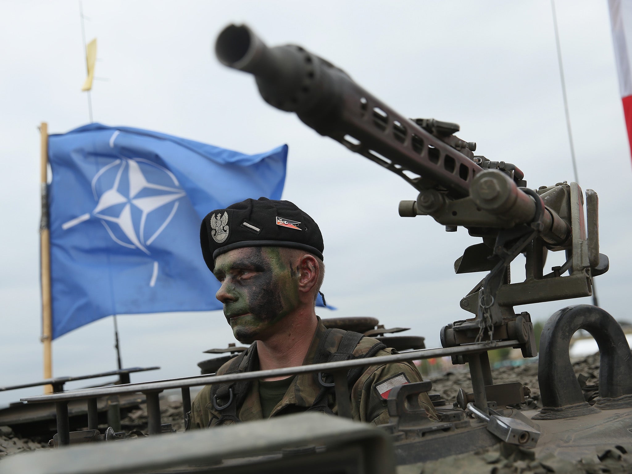 A Polish soldier sitting in a tank during a Nato exercise