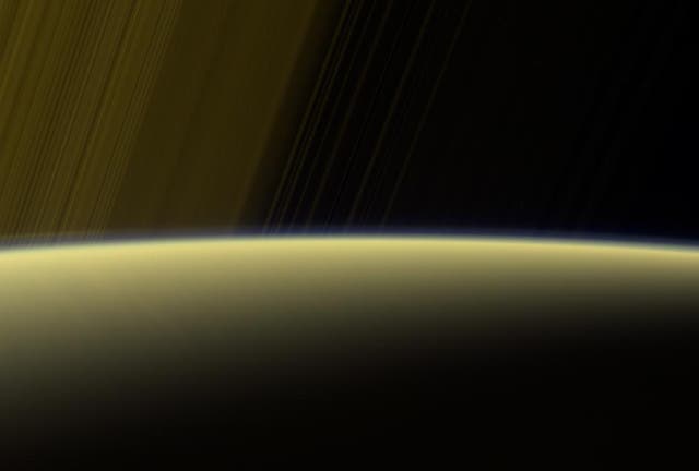 This false-color view from NASA's Cassini spacecraft gazes toward the rings beyond Saturn's sunlit horizon. Along the limb (the planet's edge) at left can be seen a thin, detached haze. This haze vanishes toward the left side of the scene.