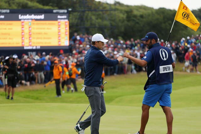 Jordan Spieth and Michael Greller share a quick fist-bump on the 17th hole of Royal Birkdale