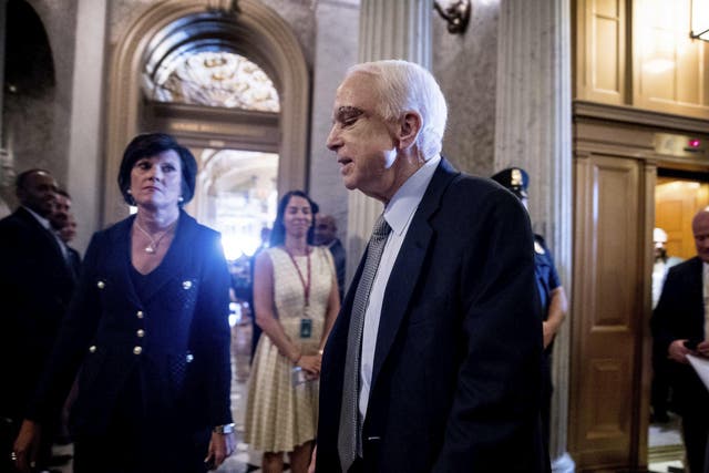 John McCain arrives on Capitol Hill as the Senate was to vote on moving head on health care with the goal of erasing much of Barack Obama's law