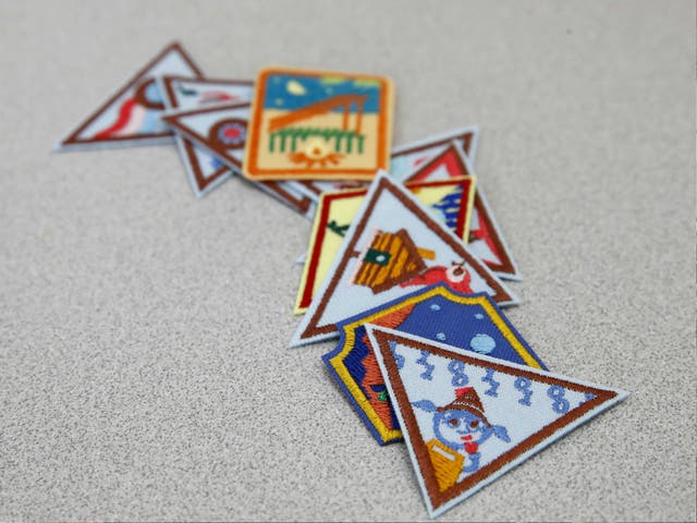 A Girl Scout badge for learning how to program a robot is seen atop a sample of new badges focused on science, technology, engineering and math in Owings Mills, Md. The new group of 23 badges takes a progressive approach to STEM and also nudges girls to become citizen scientists using the great outdoors as their laboratory. 21 July 2017