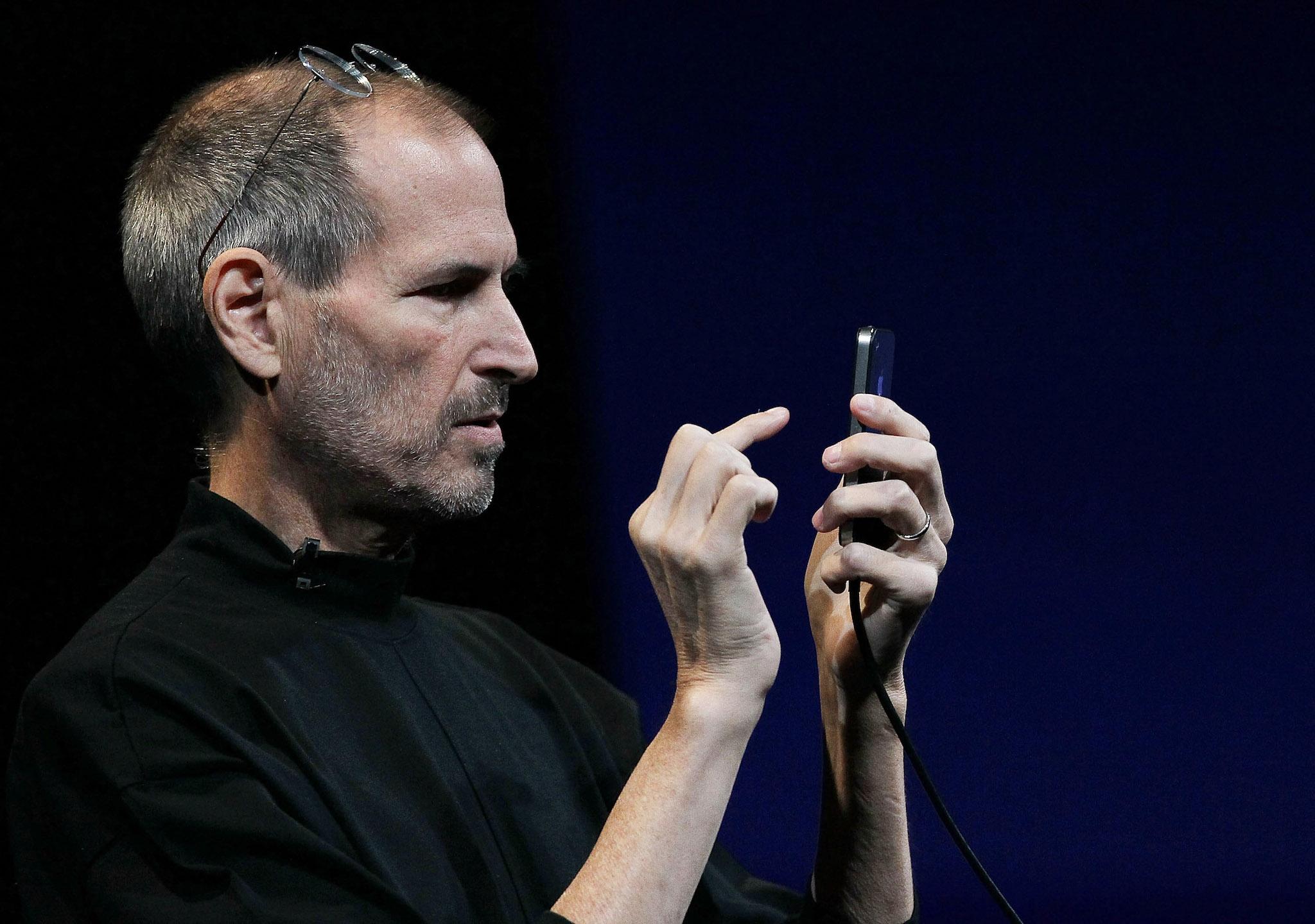 Apple CEO Steve Jobs demonstrates the new iPhone 4 as he delivers the opening keynote address at the 2010 Apple World Wide Developers conference June 7, 2010 in San Francisco, California