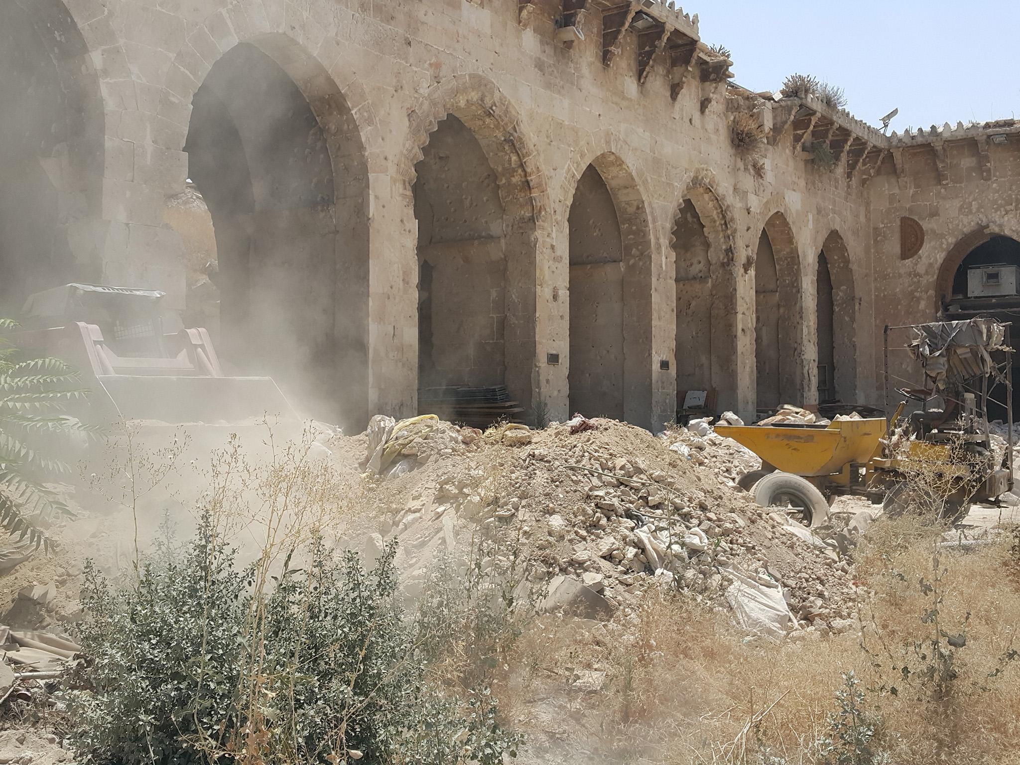 &#13;
Digger clearing stones from the courtyard of the Aleppo Umayyad Great Mosque (Photo: Nelofer Pazira)&#13;